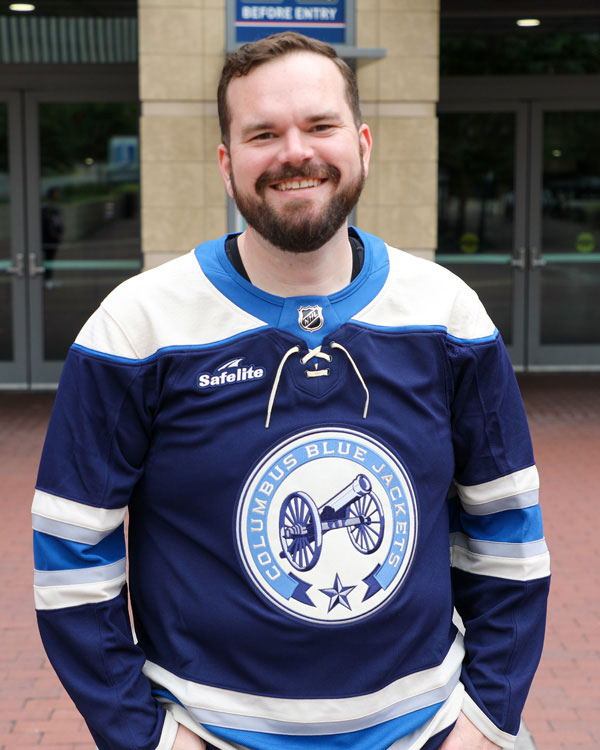 Man wearing Columbus Blue Jacket Jersey in front of the arena